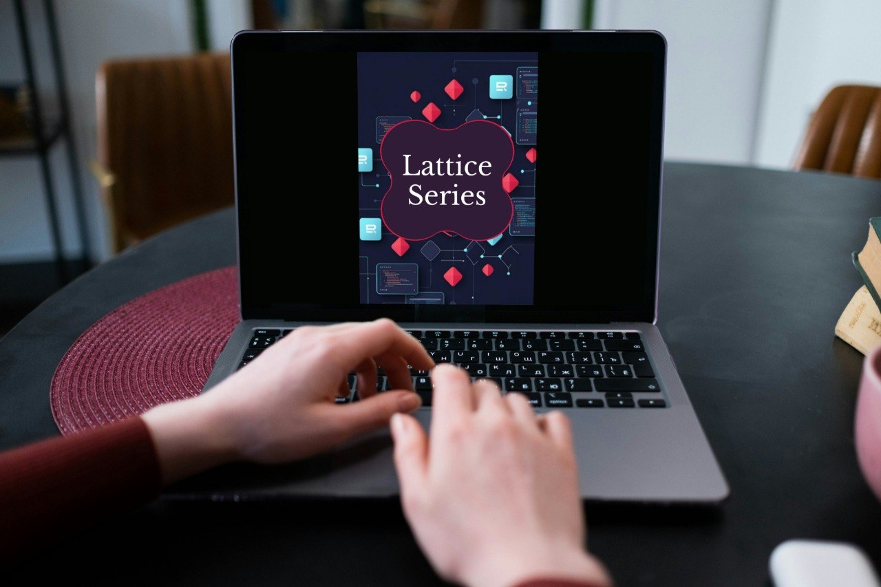 A person typing on a laptop at a table, with the laptop screen displaying a graphic titled 'Lattice Series' in white text on a dark purple and navy design with red geometric shapes.